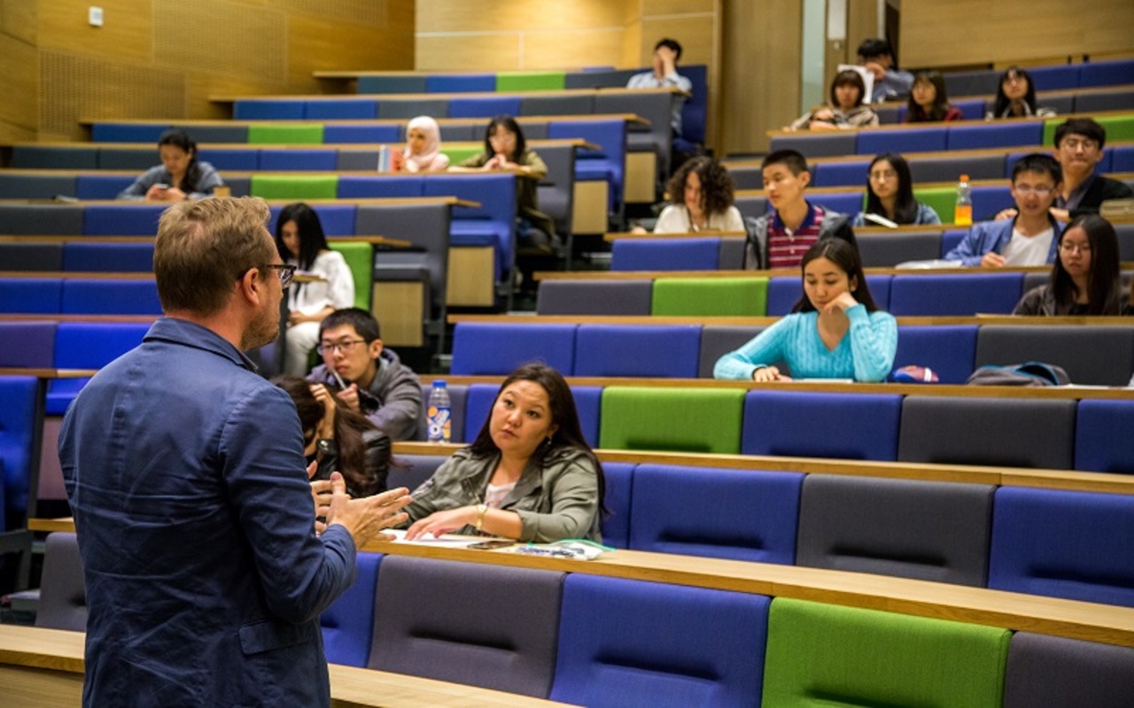 Pre sessional english students and teacher in a lecture theatre